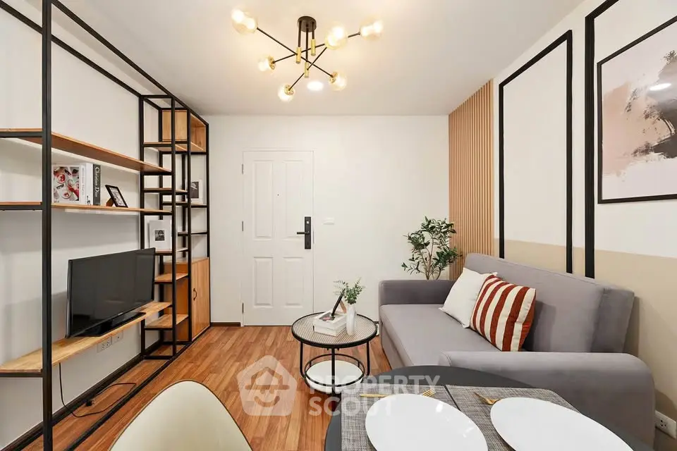 Modern living room with stylish decor and open layout, featuring a cozy sofa and elegant lighting.