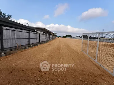 Expansive construction-ready land plot with clear skies and potential for development.