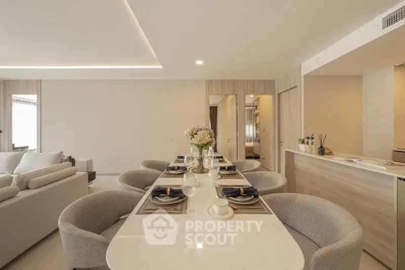 Luxurious open-plan living and dining area with elegant decor and modern furnishings.