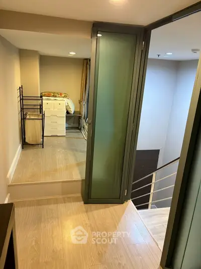 Modern interior with sleek design featuring a cozy bedroom and stylish staircase, perfect for urban living.