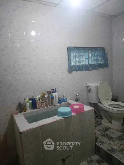 Cozy bathroom with tiled walls and essential toiletries