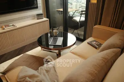 Cozy living room with modern furniture and balcony view, perfect for relaxation.