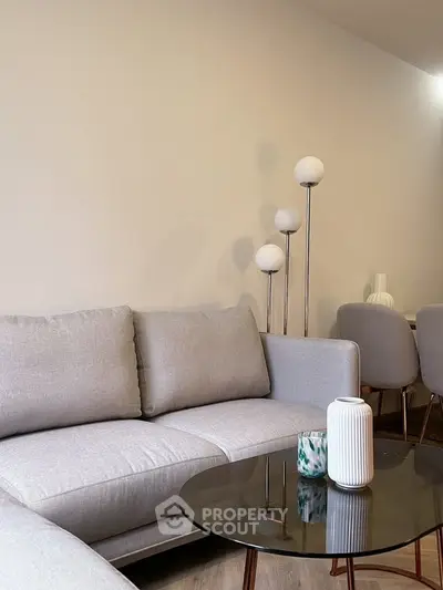 Stylish modern living room with cozy gray sofa and elegant decor
