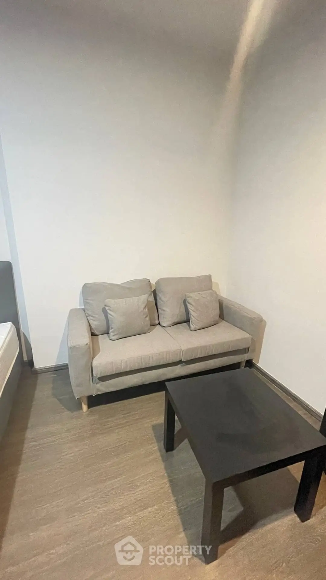 Cozy living room with modern gray sofa and sleek black coffee table.