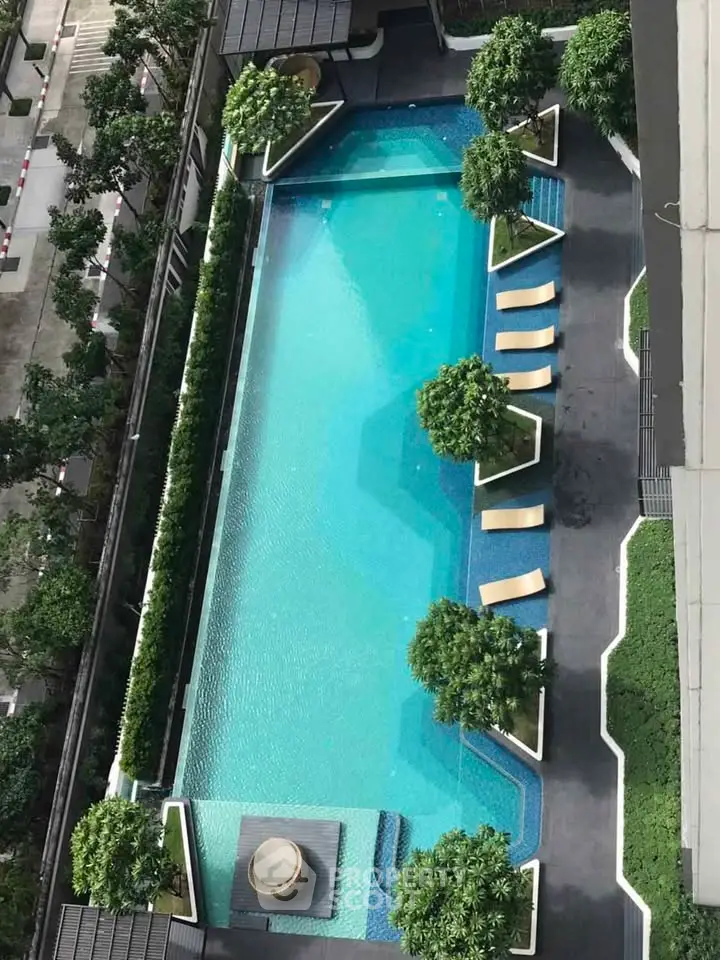 Luxurious rooftop pool with lush greenery and modern design in a high-end residential complex.