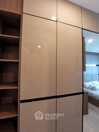 Modern bedroom with sleek built-in wardrobe and cozy bed setup