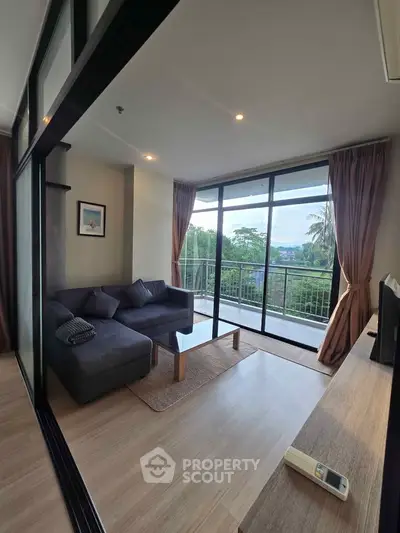 Spacious living room with large windows and balcony offering scenic views, perfect for relaxation.