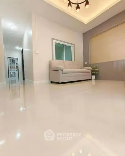 Modern living room with sleek design and cozy sofa, perfect for relaxation and entertaining guests.