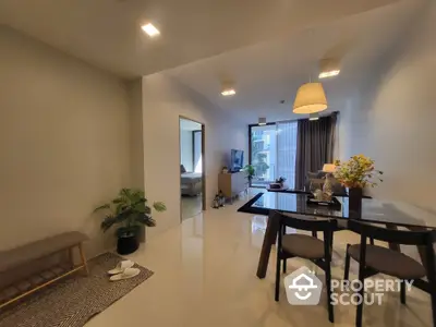 Modern open-plan living and dining area with sleek furnishings and natural light.