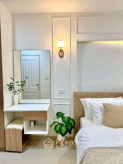 Elegant bedroom with modern decor, featuring a stylish vanity and cozy bed setup.