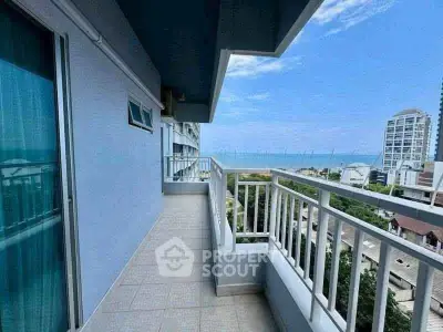 Spacious balcony with stunning ocean view in modern high-rise building.