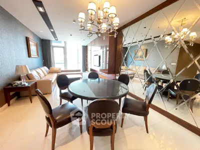 Luxurious living room with elegant dining area and mirrored wall