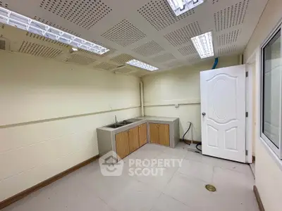 Spacious utility room with modern sink and ample storage cabinets.