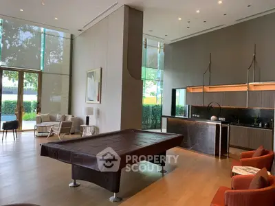 Luxurious modern living room with pool table and stylish kitchenette