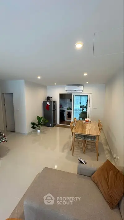 Modern open-plan living and dining area with sleek design and natural light