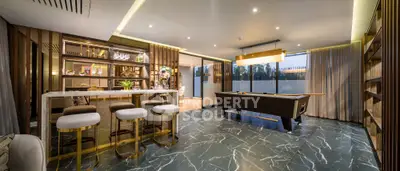 Luxurious modern living room with elegant bar and pool table, featuring marble flooring and ambient lighting.