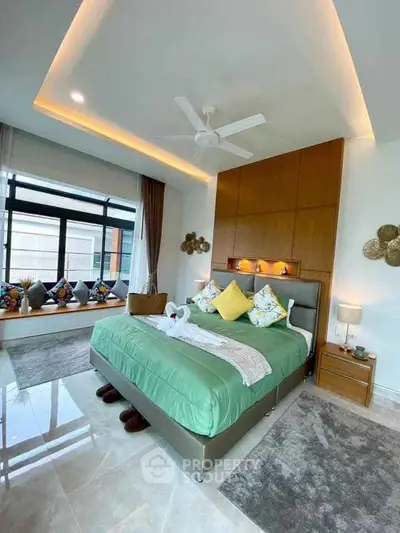 Luxurious bedroom with modern decor and large window for natural light