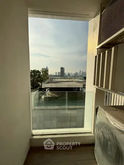 Stunning city view from modern balcony with glass railing, perfect for urban living.