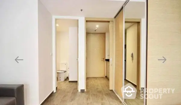 Spacious and well-lit corner unit with a large living area, modern flooring, and multiple room access, perfect for urban living.