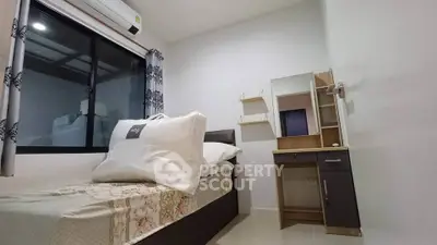 Cozy bedroom with single bed, air conditioning, and modern vanity desk.