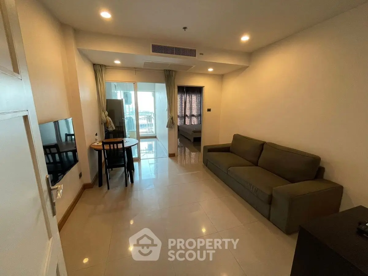 Modern living room with cozy sofa and dining area in open layout apartment