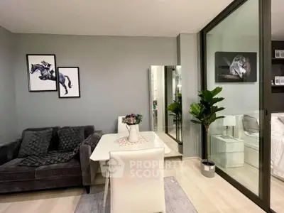 Modern living room with elegant decor and glass partition to bedroom
