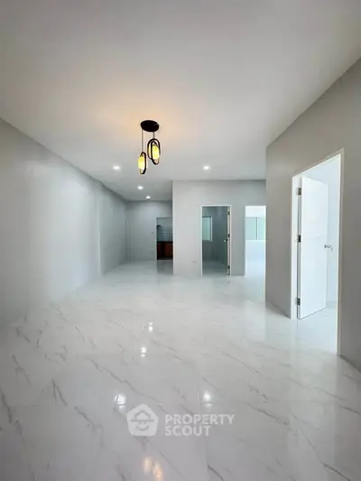 Spacious modern interior with marble flooring and elegant lighting, perfect for contemporary living.