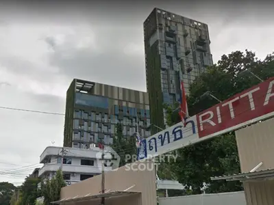 Modern urban building with unique architectural design and lush greenery facade.