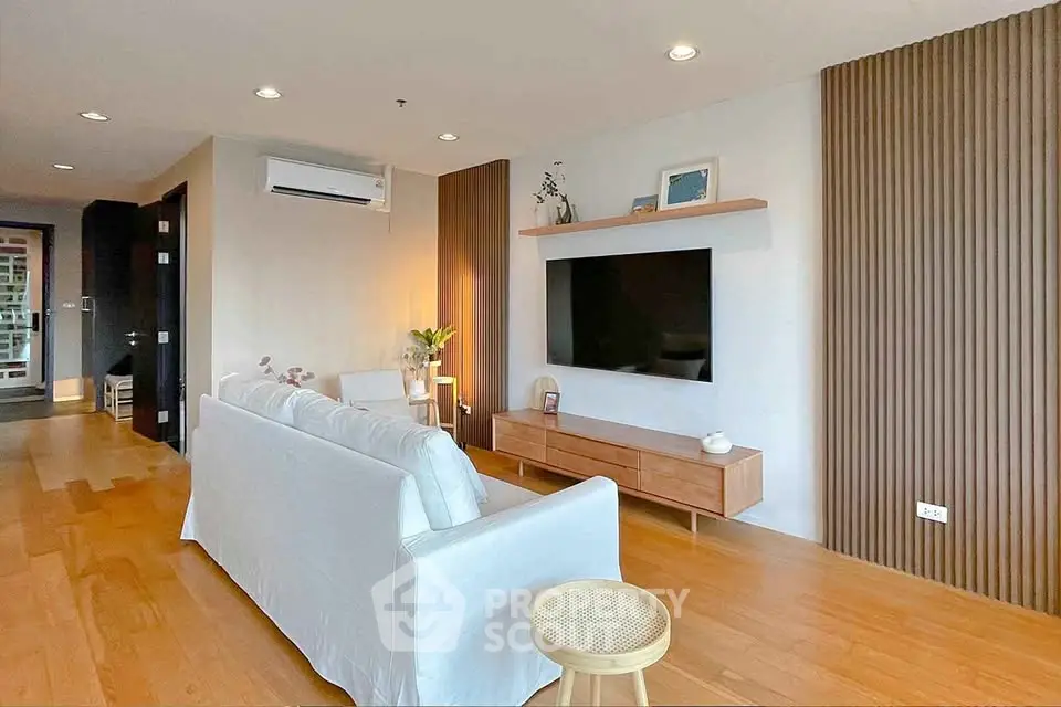 Modern living room with sleek wooden flooring and stylish decor