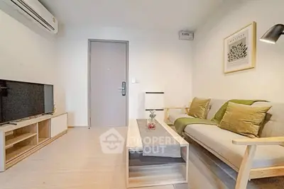 Modern living room with stylish furniture and wall art, featuring a cozy ambiance.