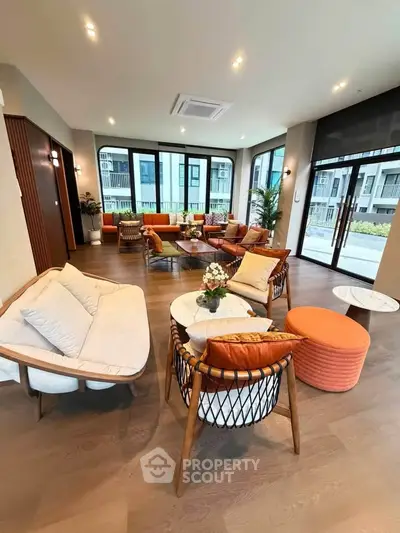 Luxurious modern living room with elegant furniture and large windows offering natural light and a stunning view.