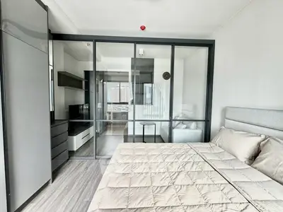 Modern bedroom with glass partition and stylish decor in a contemporary apartment.