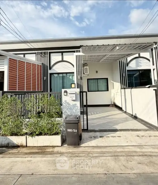 Modern single-story house with stylish facade and driveway