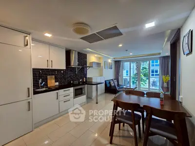 Modern open-plan kitchen and living area with sleek design and natural light