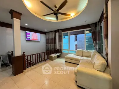 Spacious living room with modern ceiling fan and cozy sectional sofa