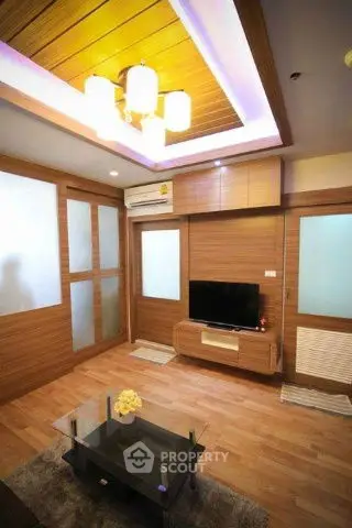 Modern living room with wooden accents and ambient lighting