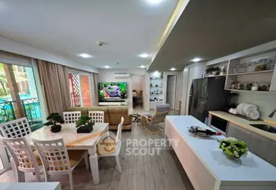 Spacious open-plan living room and kitchen with modern decor and garden view.