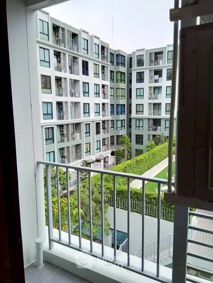 Modern apartment building view from balcony with lush garden