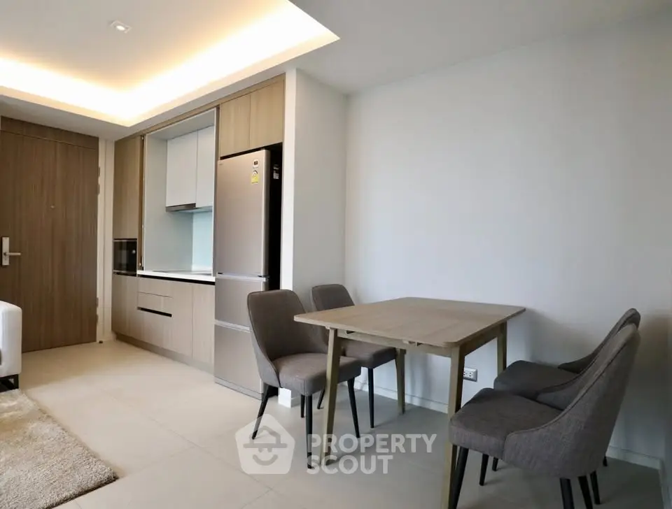 Modern open-plan kitchen and dining area with sleek design and neutral tones.