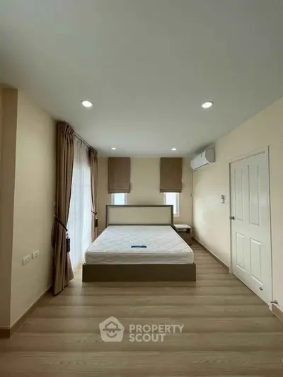 Spacious bedroom with modern decor and natural light