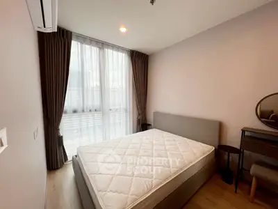 Cozy bedroom with modern decor and large window for natural light