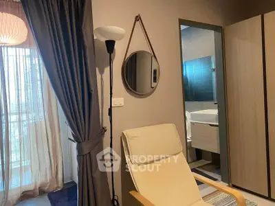 Modern interior with cozy chair, elegant curtains, and stylish bathroom view.