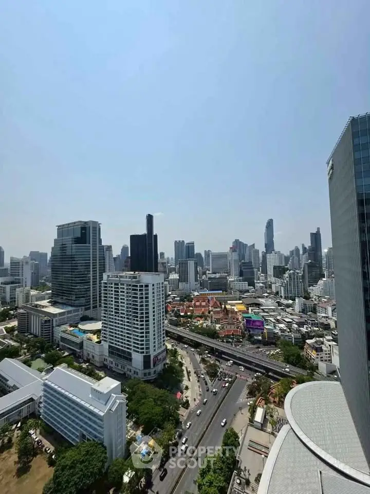 Stunning cityscape view from a high-rise building showcasing urban skyline and bustling streets.