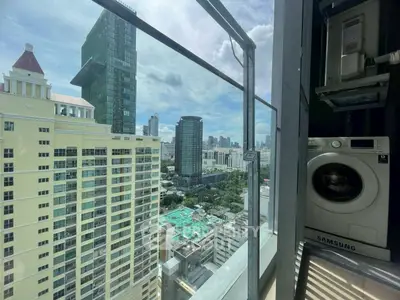 Stunning city view from high-rise balcony with modern washing machine.