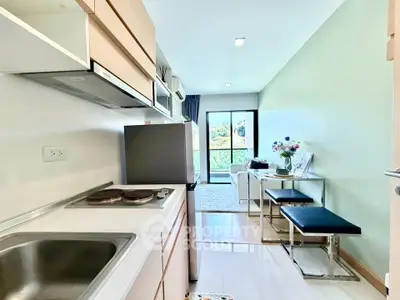 Modern kitchen with open layout and cozy living area in bright apartment