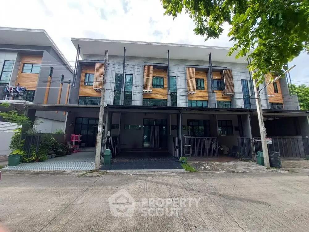 Modern townhouse exterior with contemporary design and spacious driveway
