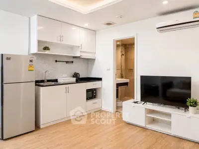 Modern open-layout kitchen and living room with sleek appliances and stylish decor.