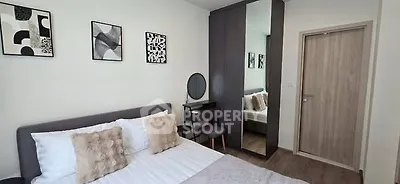 Modern bedroom with stylish decor and mirrored wardrobe in a cozy apartment.