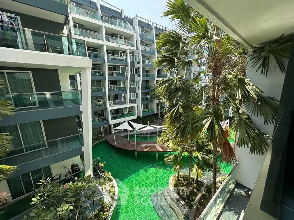 Luxurious condominium with stunning pool view and lush greenery
