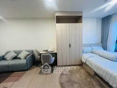 Modern studio apartment with cozy living area and stylish furniture
